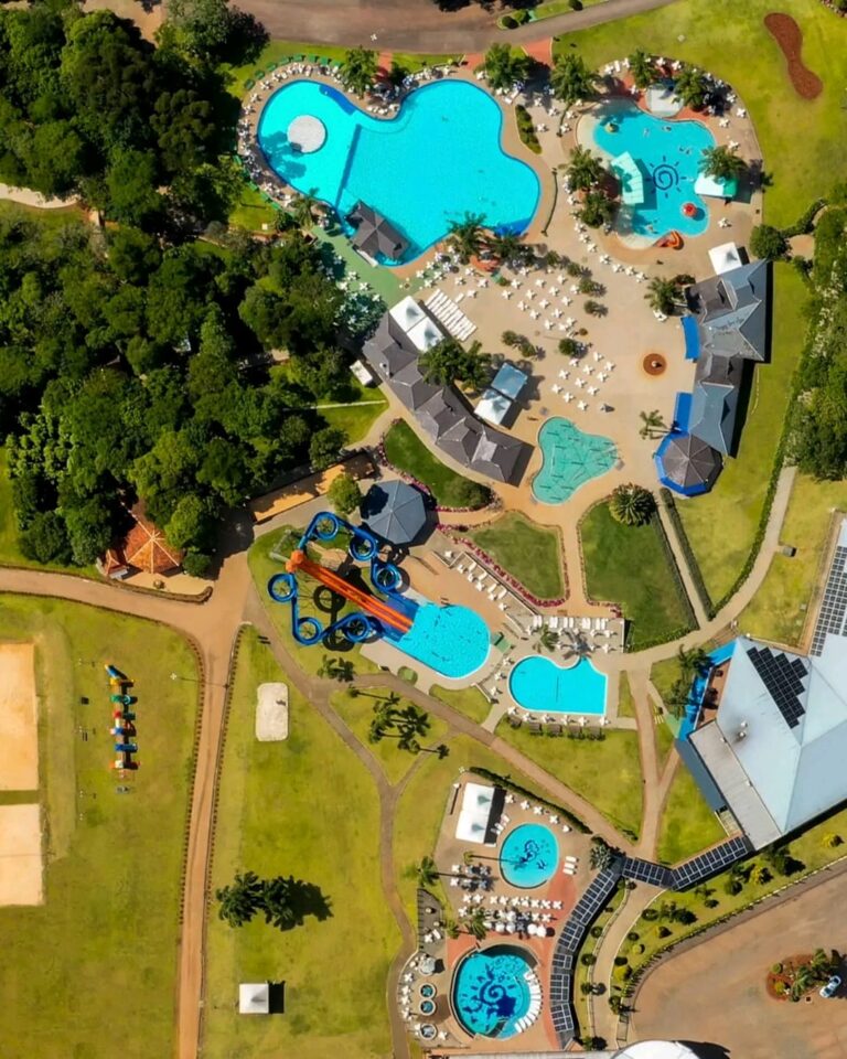 Vista aérea de complexo de lazer com piscinas termais azuis, tobogãs e infraestrutura de resort em Machadinho, Rio Grande do Sul.